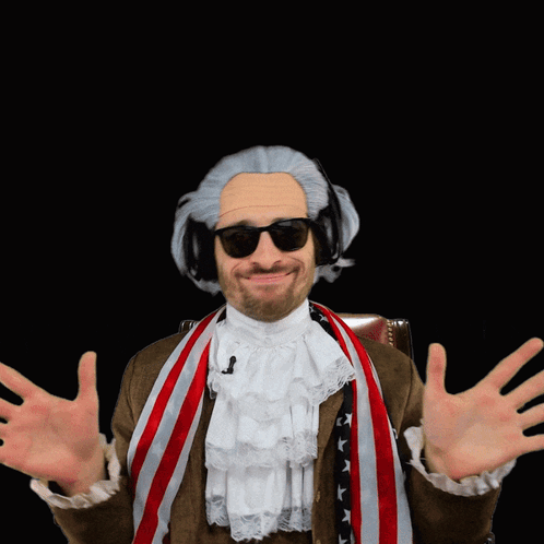 A Man Wearing A Wig And Sunglasses Holds His Hands Out GIF