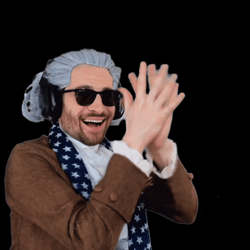 A Man Wearing A Wig And Sunglasses Holds Up His Hands GIF