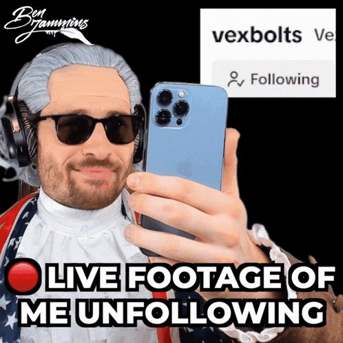 A Man Wearing A Wig And Sunglasses Is Taking A Selfie With The Words Live Footage Of Me Unfollowing Behind Him GIF