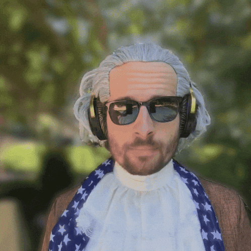 A Man Wearing A Wig And Sunglasses Is Wearing Headphones And A Scarf GIF