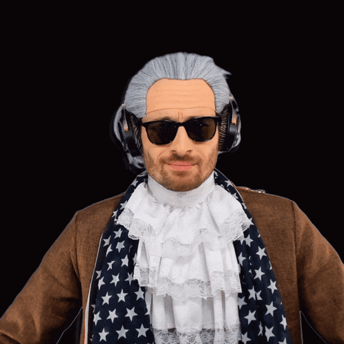A Man Wearing A Wig And Sunglasses Is Wearing Headphones And An American Flag Scarf GIF