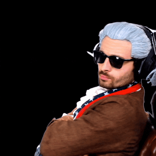 A Man Wearing A Wig And Sunglasses With Headphones On His Head GIF