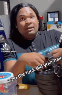 A Man Wearing A Wig Is Holding A Black Purse And Says Who The Fuck Did Your Hair . GIF