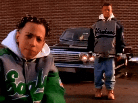 A Man Wearing A Yankees Jacket Stands Next To A Boy Wearing A Green Jacket GIF