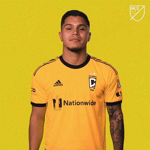 A Man Wearing A Yellow Adidas Shirt With Nationwide On It GIF