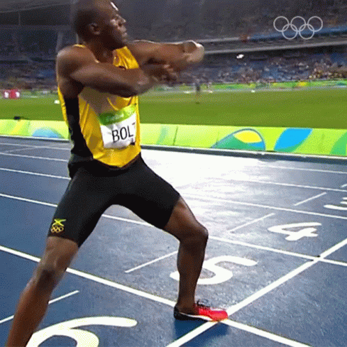 A Man Wearing A Yellow And Black Shirt With Bolt On It GIF