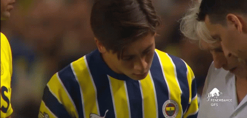 A Man Wearing A Yellow And Blue Striped Shirt With The Word Fenerbahce On The Front GIF