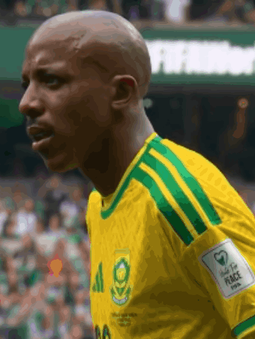 A Man Wearing A Yellow And Green Jersey With The Number 20 On It GIF