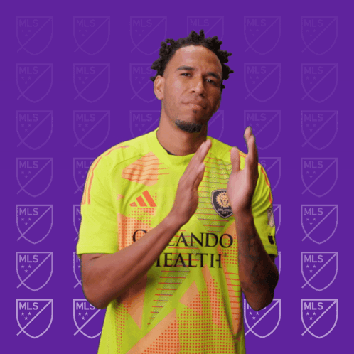 A Man Wearing A Yellow And Orange Jersey That Says Mls GIF