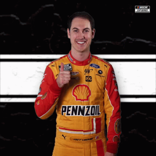 A Man Wearing A Yellow And Red Pennzoil Racing Suit Giving A Thumbs Up GIF