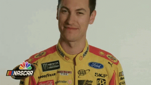 A Man Wearing A Yellow And Red Racing Suit With Nascar Written On The Bottom GIF