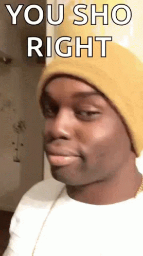 A Man Wearing A Yellow Beanie Is Making A Funny Face . GIF