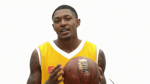 A Man Wearing A Yellow Easterns Automotive Group Jersey Holds A Basketball GIF