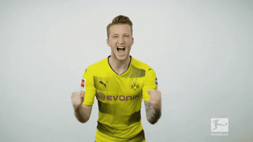 a man wearing a yellow evonik shirt is screaming