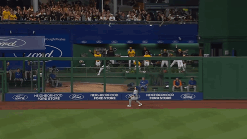 A Man Wearing A Yellow Gh Jersey Stands In The Dugout GIF
