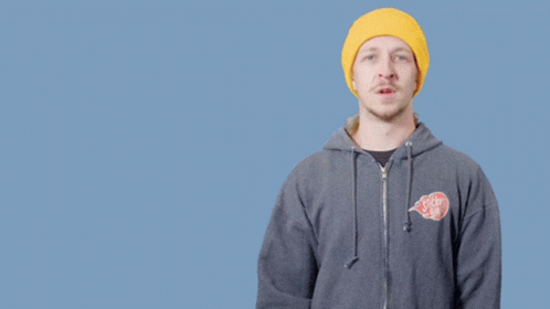 A Man Wearing A Yellow Hat And A Gray Hoodie Says " Don 'T Be A " GIF