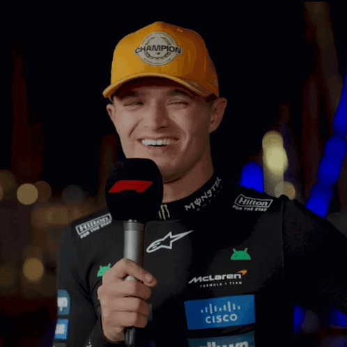 A Man Wearing A Yellow Hat That Says Champion On It GIF
