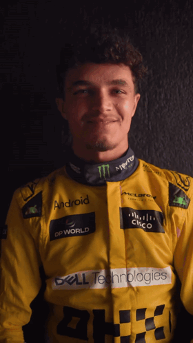 A Man Wearing A Yellow Jacket With Logos For Dell Technologies And Monster GIF