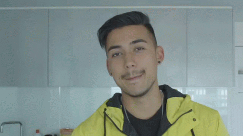 A Man Wearing A Yellow Jacket With Melbourne Written On The Bottom GIF