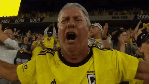 A Man Wearing A Yellow Jersey With The Letter C On The Front GIF