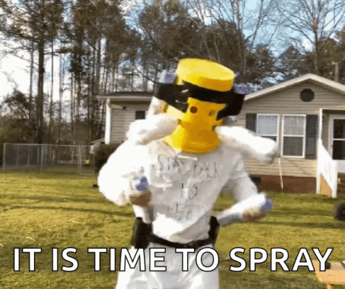 A Man Wearing A Yellow Mask Is Spraying Something In Front Of A House With The Words " It Is Time To Spray " GIF