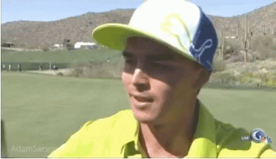 A Man Wearing A Yellow Shirt And A Blue And White Hat With The Word Puma On It GIF