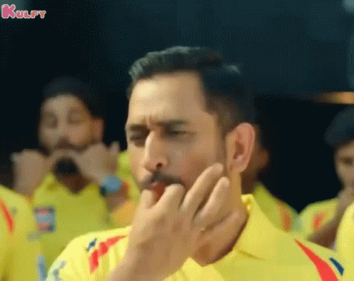 A Man Wearing A Yellow Shirt Is Covering His Mouth With His Hand And The Word Kulfy Is On The Bottom GIF