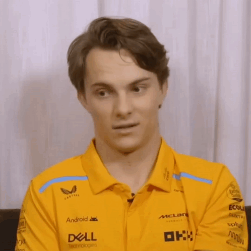 A Man Wearing A Yellow Shirt That Says Dell On The Sleeves GIF