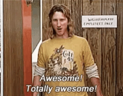 A Man Wearing A Yellow T-Shirt Is Standing In Front Of A Wooden Door . GIF