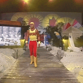 A Man Wearing A Yellow Tank Top That Says Hulk Hogan Walks Down A Wooden Ramp GIF