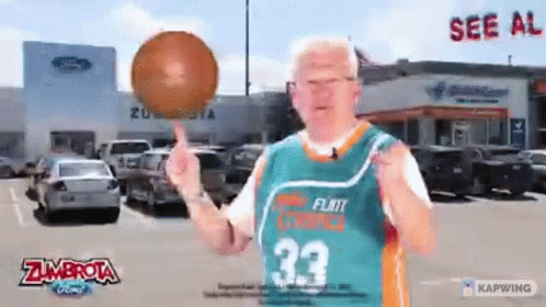 A Man Wearing A Zumbrota Jersey Is Holding A Basketball GIF