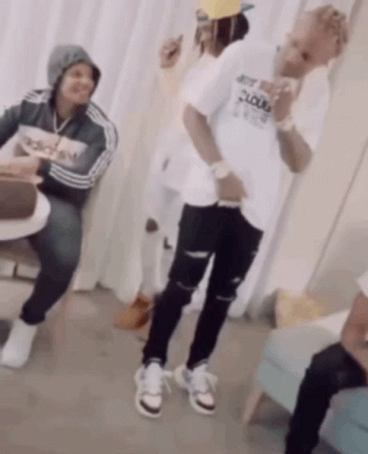 A Man Wearing An Adidas Shirt Is Dancing In A Room GIF