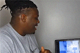 A Man Wearing An Adidas Shirt Is Giving A Thumbs Up In Front Of A Television GIF