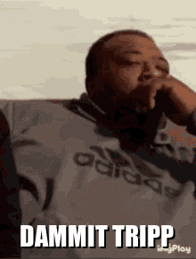 A Man Wearing An Adidas Shirt Is Smoking A Cigarette And Says Dammit Tripp . GIF