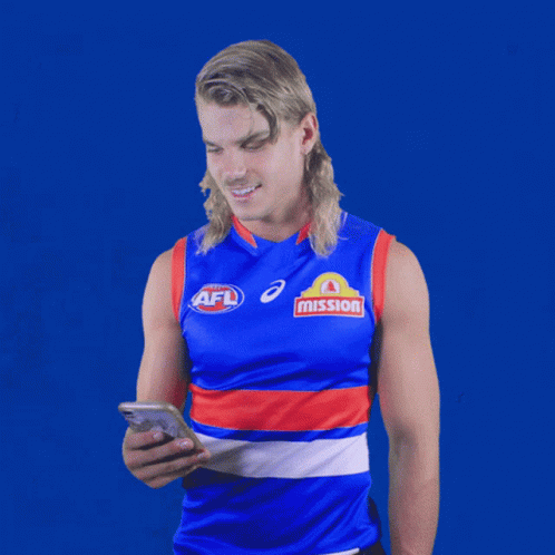 A Man Wearing An Afl Jersey Looks At A Cell Phone GIF