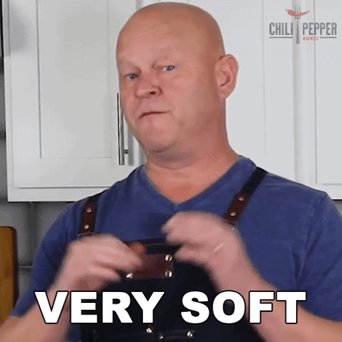 A Man Wearing An Apron Says Very Soft GIF