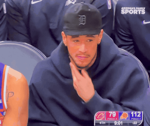 A Man Wearing An Arizona 'S Family Sports Hat Sits In A Stadium GIF