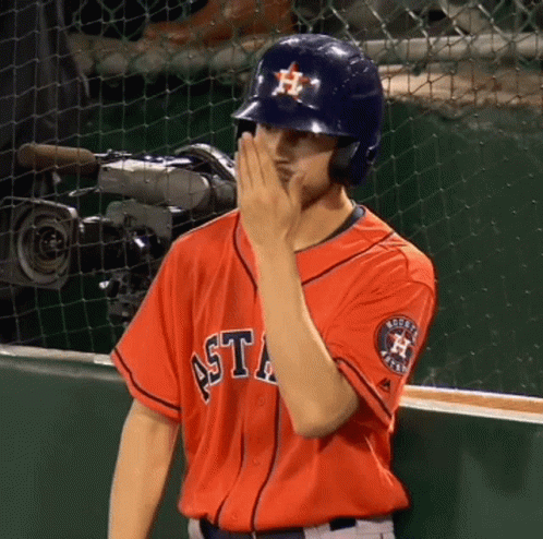 A Man Wearing An Astros Jersey Covers His Face With His Hand GIF