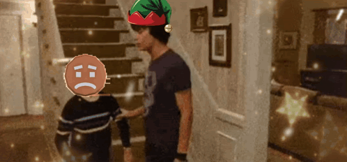 A Man Wearing An Elf Hat Is Talking To A Boy With A Sad Face GIF