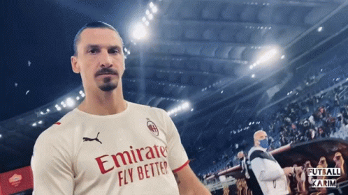 a man wearing an emirates fly better jersey