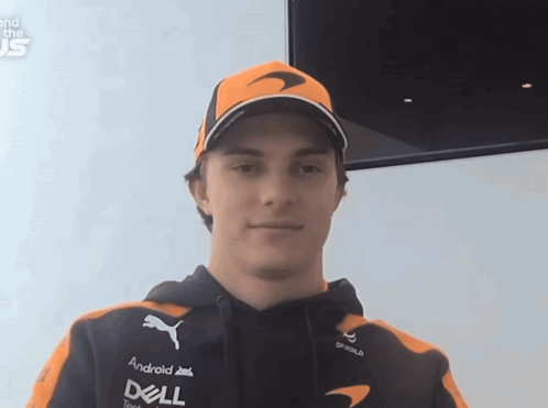 A Man Wearing An Orange Hat And A Black Hoodie With Dell On The Front GIF