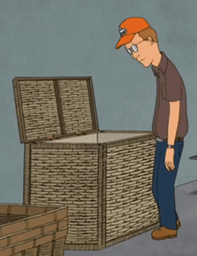 A Man Wearing An Orange Hat Is Looking Into A Wicker Box GIF