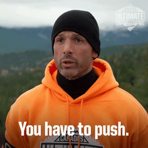 A Man Wearing An Orange Hoodie And A Black Beanie Says " You Have To Push " GIF