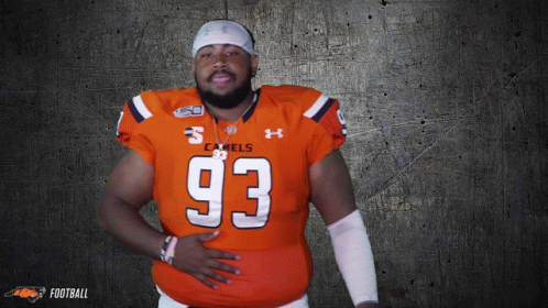 a man wearing an orange jersey with the number 93