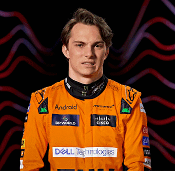A Man Wearing An Orange Racing Suit With Dell Technologies Logos On It GIF