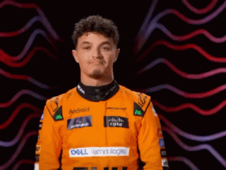 A Man Wearing An Orange Racing Suit With Dell Technologies On The Front GIF
