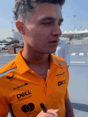 A Man Wearing An Orange Shirt That Says Dell Technologies On It GIF