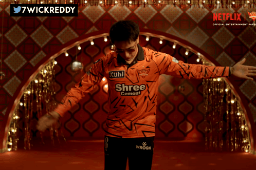 A Man Wearing An Orange Shirt That Says Kuhl Shree On It GIF