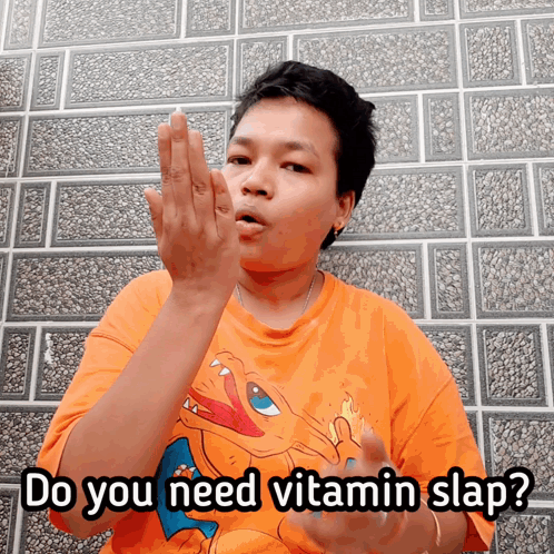 A Man Wearing An Orange Shirt With A Pokemon On It Says Do You Need Vitamin Slap GIF