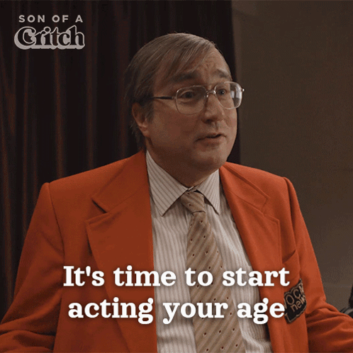 Man In Orange Suit And Tie Saying Time To Start Acting Your Age GIF